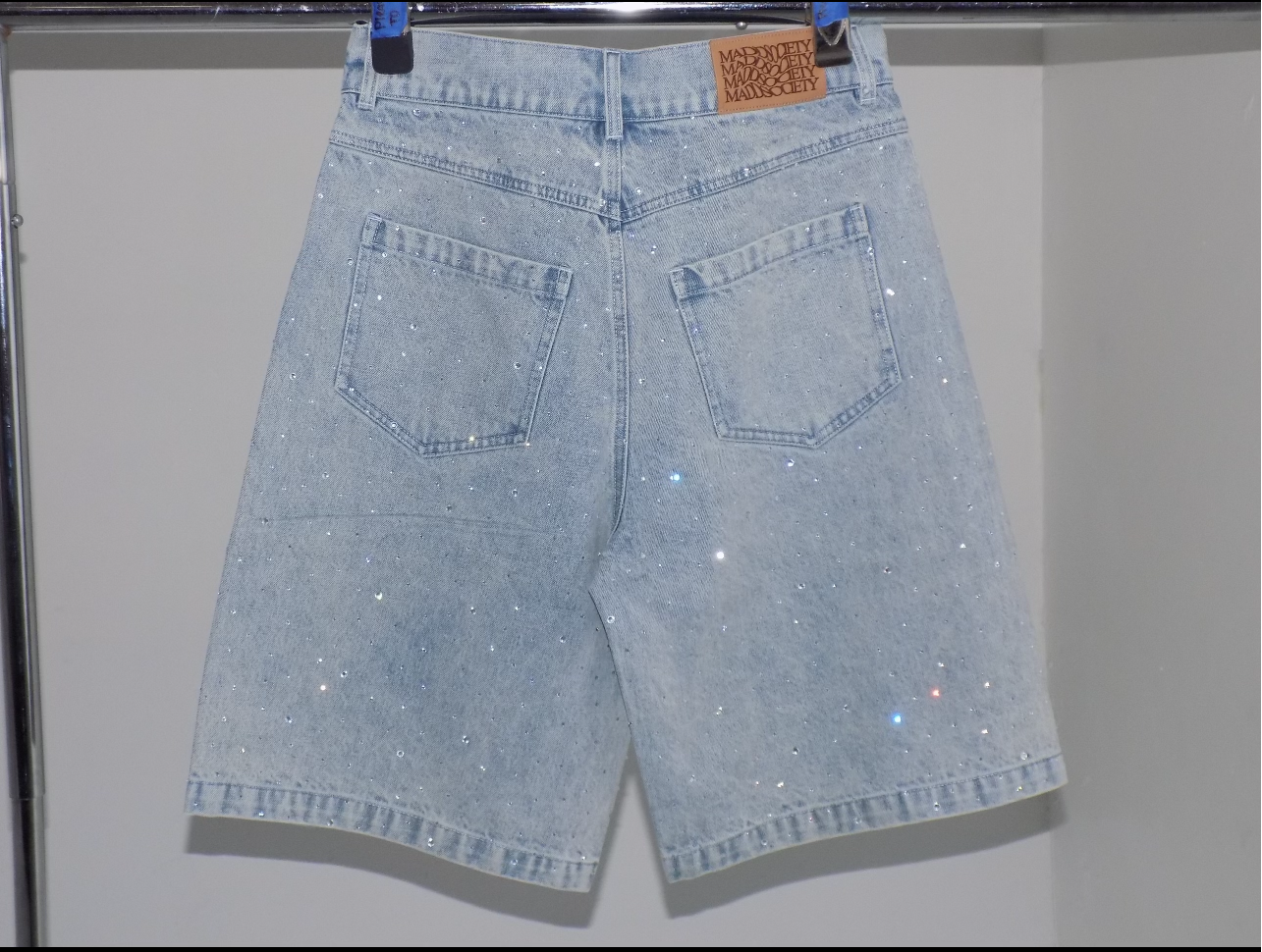 Light blue denim shorts with a brand label on a white background